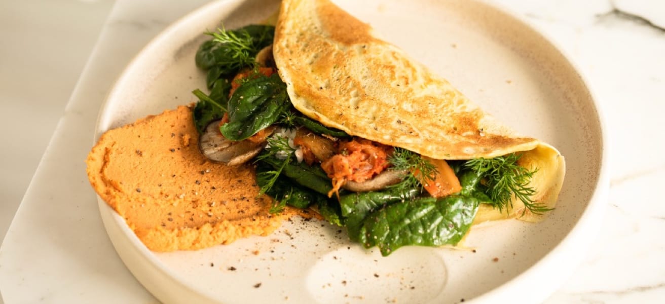 Simple omelette with spinach served on a white plate
